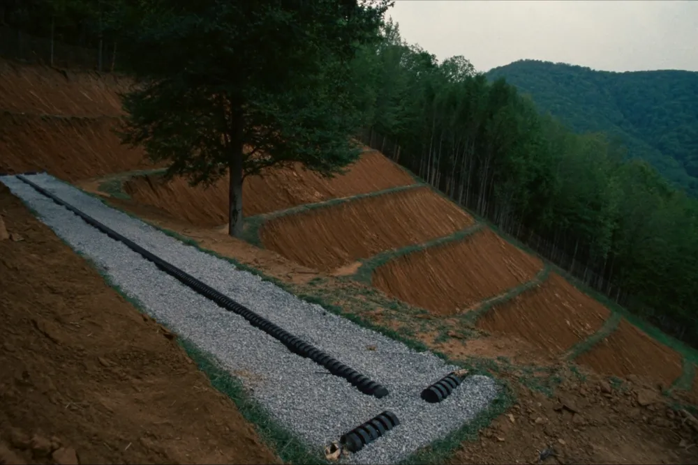 Gravel-bedded drainfield trench on a benched hillside terrace in Sevier County, Tennessee