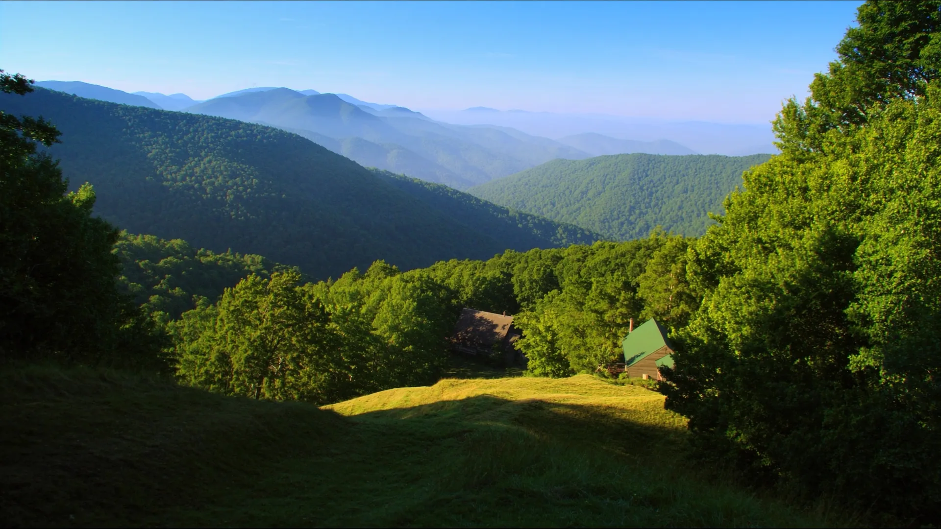 Layered forested ridges and a cabin above a valley in Sevier County, Tennessee