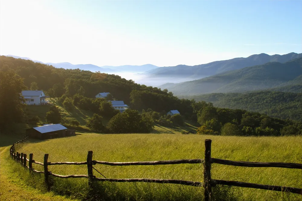 Pasture, split-rail fence, and layered foothill ridges in Wears Valley, Tennessee